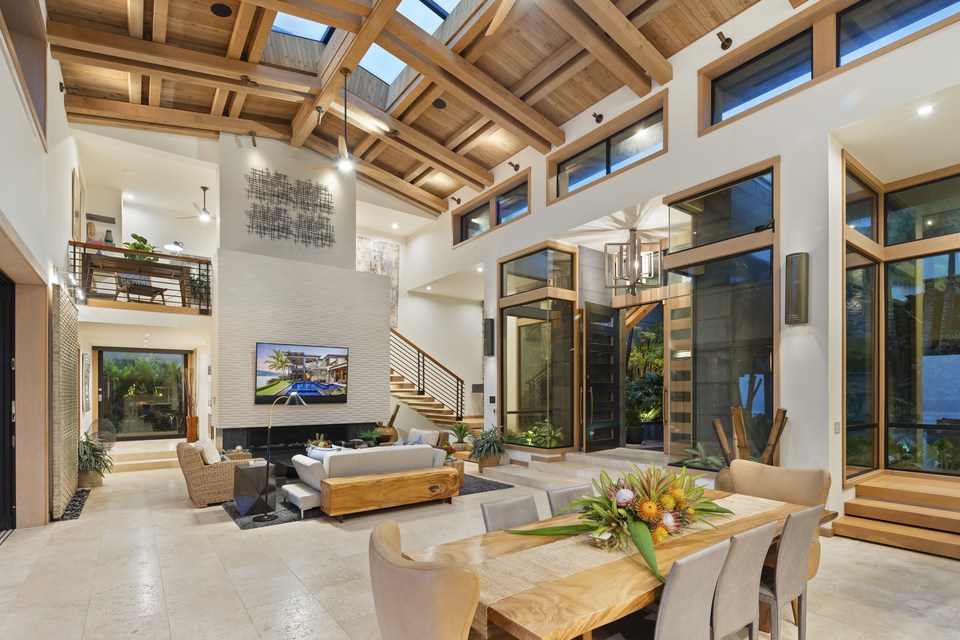 Double-height living room with exposed timber roof structure.