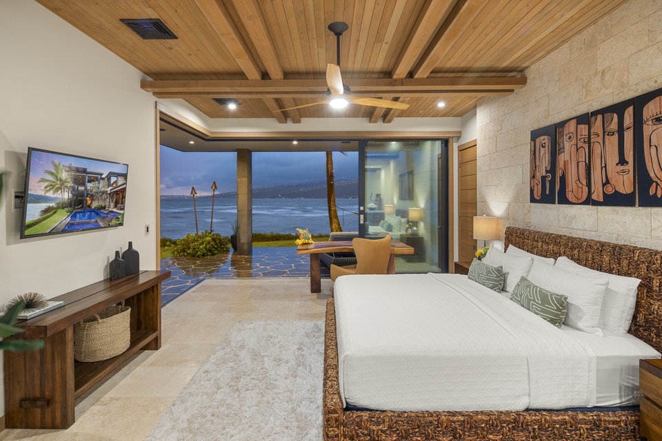 Bedroom with timber ceiling and a wide ocean view.