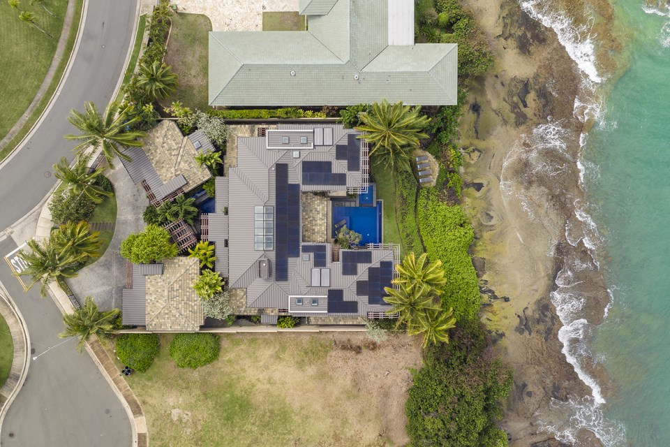 Top-down aerial view of the residence at the shoreline.