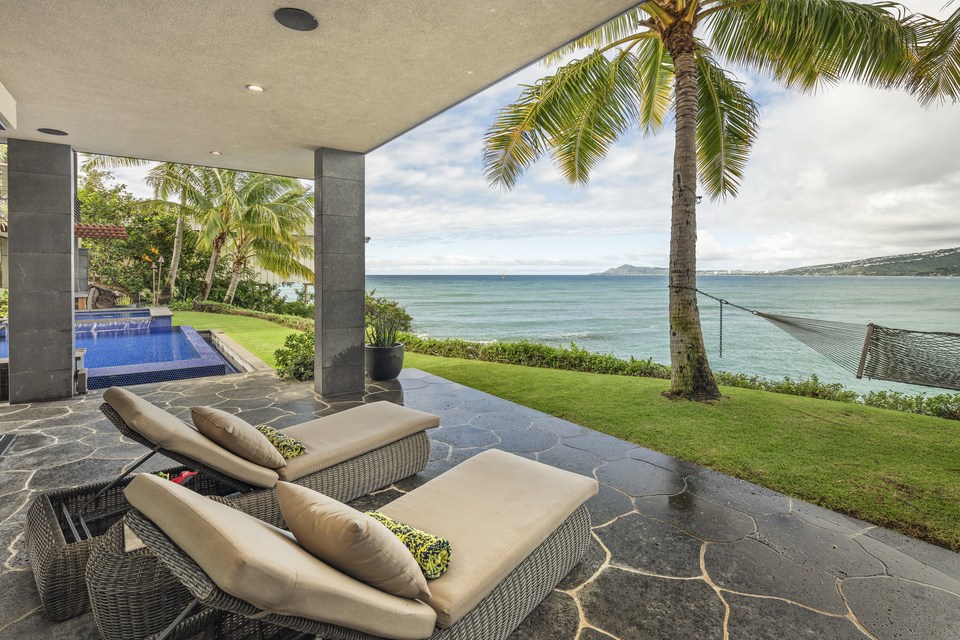 Pool terrace and outdoor seating facing the water.