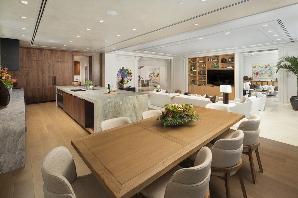Open kitchen and dining room with warm wood and stone finishes.