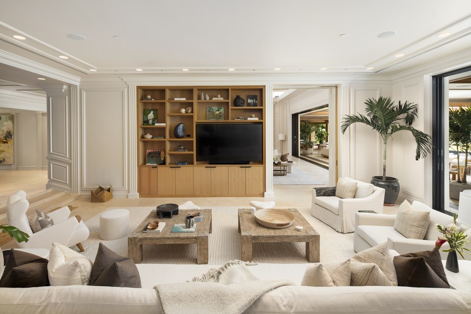 Art-filled media room opening toward adjacent living spaces.