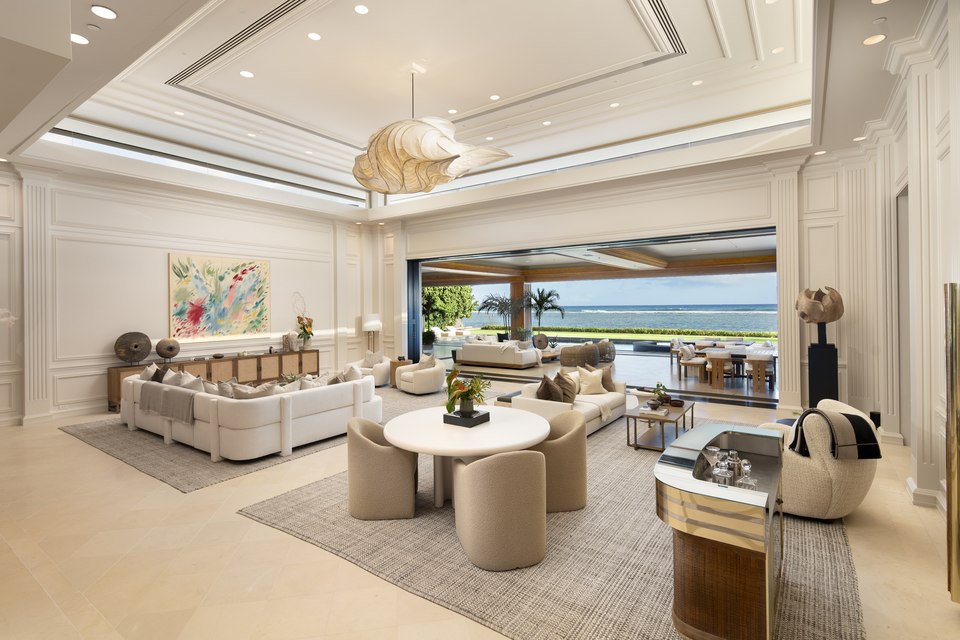 Living room opening fully to the oceanfront terrace.