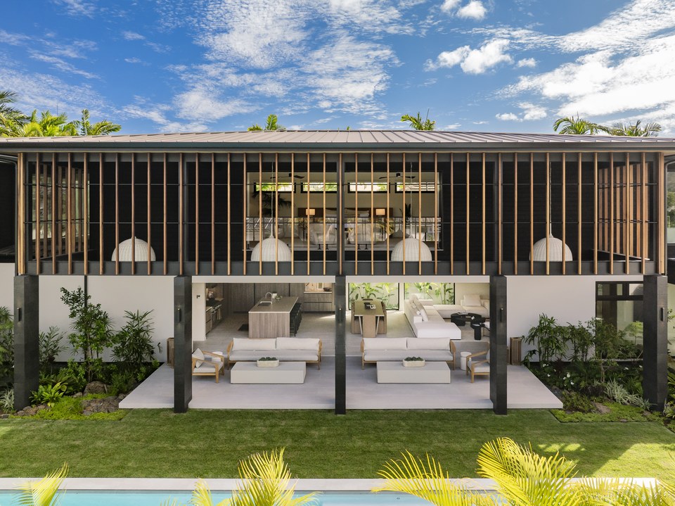 Two-story garden façade with timber screens and broad openings to the interior.