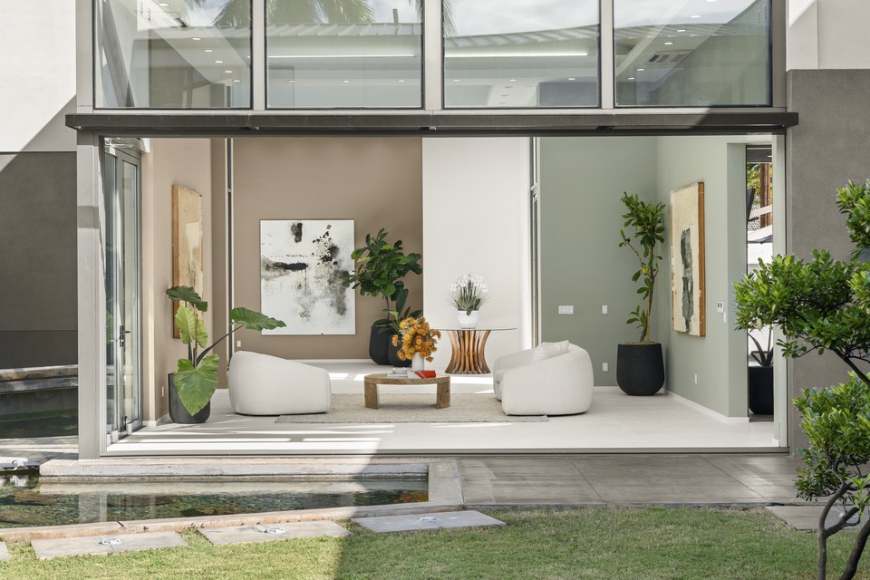 Living room opening across the lawn to the opposite courtyard wing.