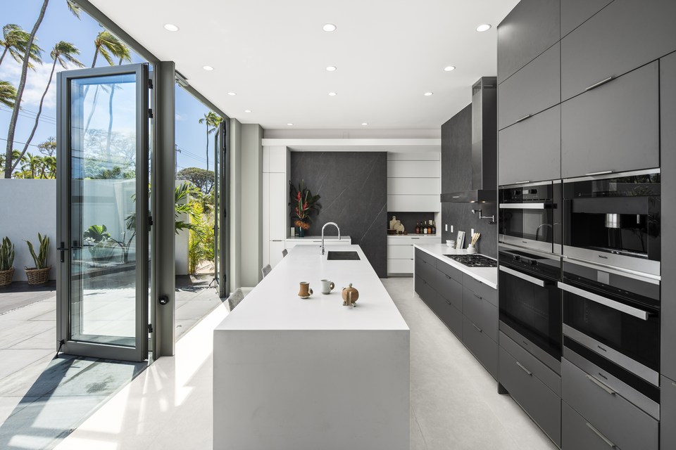 Black-and-white kitchen with a long central island.