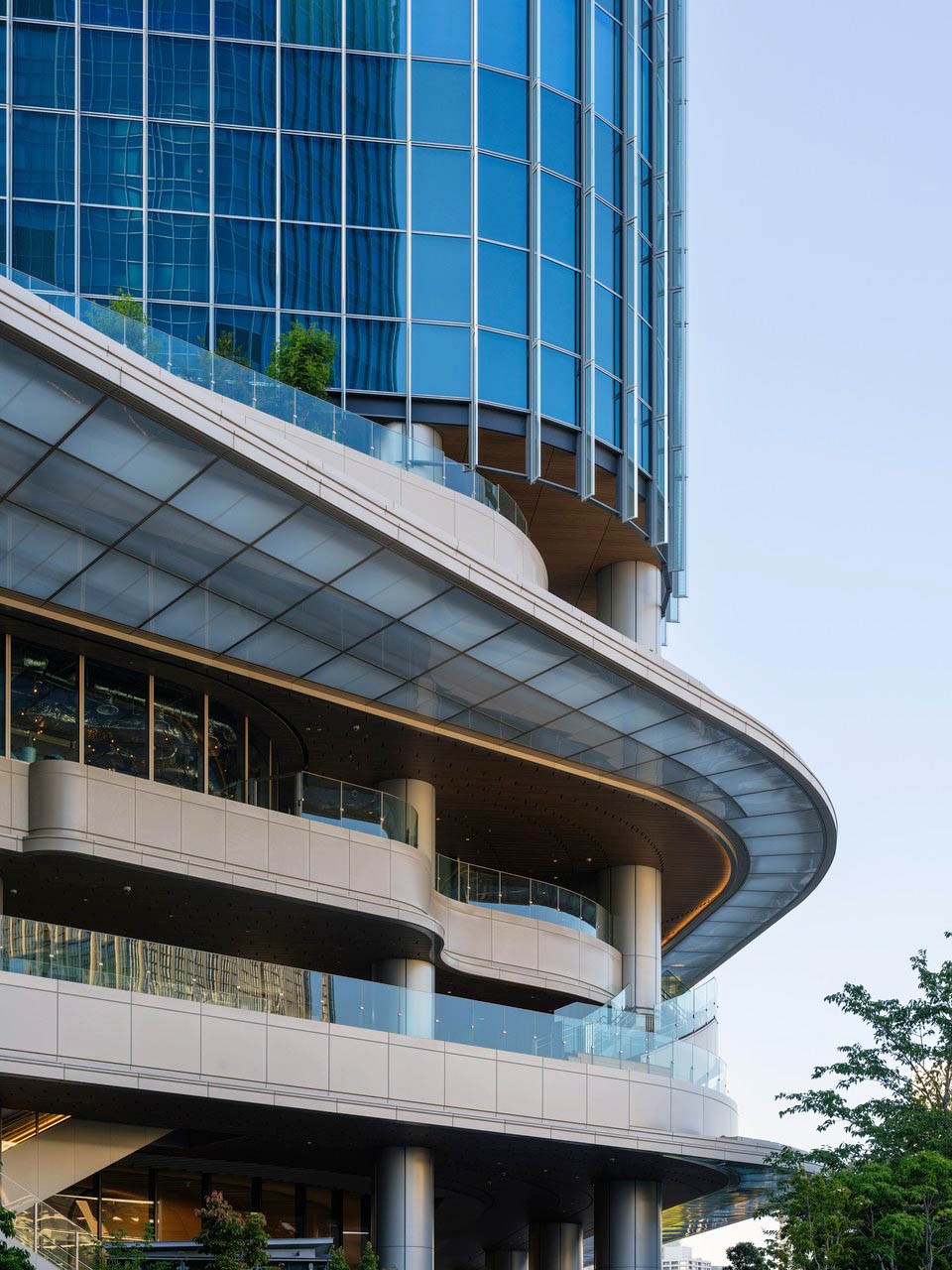Curving contemporary tower and terraces photographed in Tokyo.