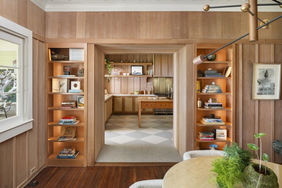 Tailored timber kitchen with layered shelving and a checkerboard floor.