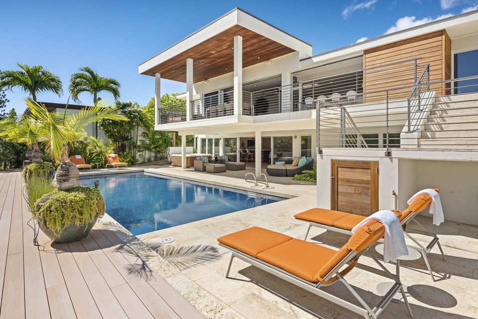 Hawaiʻi residence and pool photographed beneath a clear blue sky.